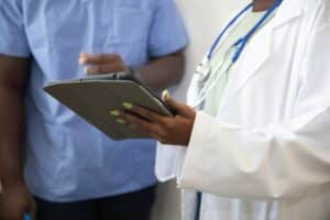 Two healthcare professionals with a tablet